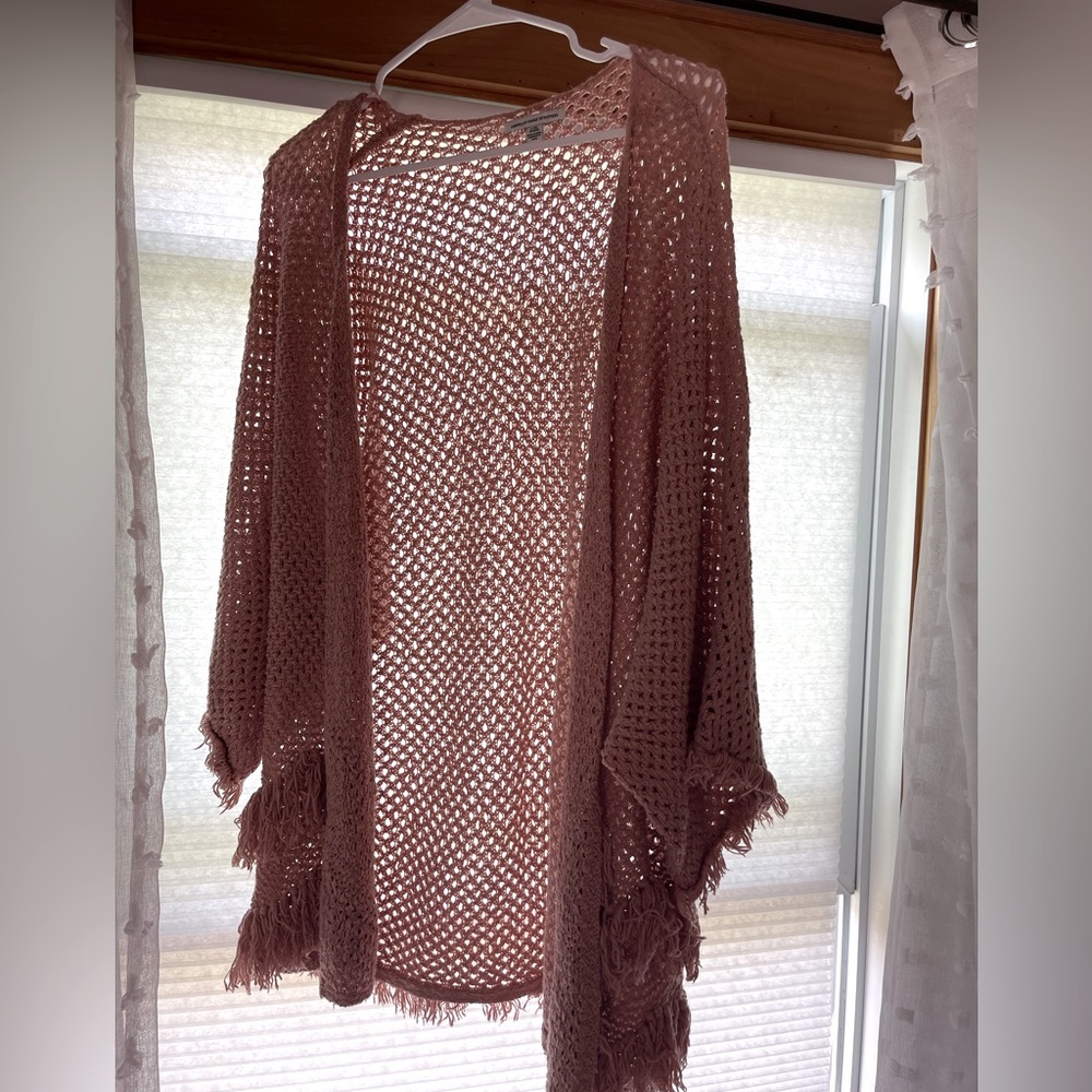 Lightweight open knit cover up. Dolman arms with fringe on the ends.